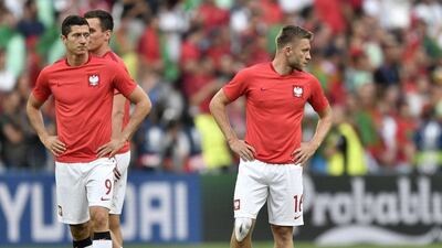 Poland’s Robert Lewandowski, left, and Jakub Blaszczykowski walk on the pitch before the match. Martin Meissner / AP Photo