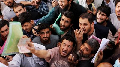 Afghans outside Kabul's passport office after Taliban officials said they would start issuing documents again. Photo: Reuters