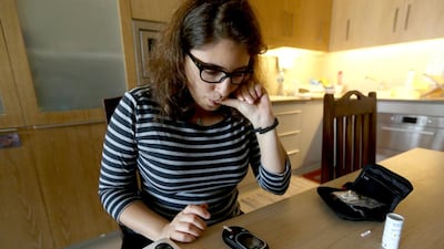 Sara Taher, a pre-diabetic checks her sugar levels. Sammy Dallal / The National