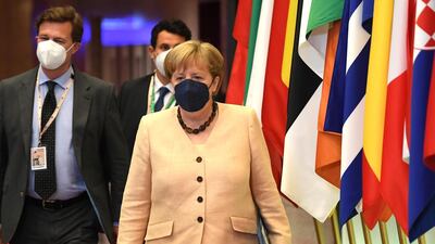 Angela Merkel leaves at the end of an EU summit at the European Council building in Brussels. AP Photo