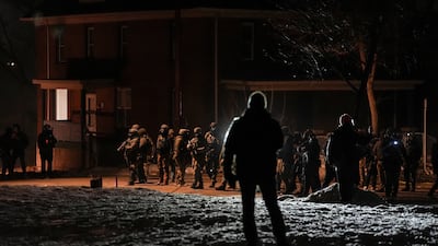 Federal law enforcement personnel stand guard in Minneapolis, as tension rises after agents were involved in a shooting incident in the city. Reuters