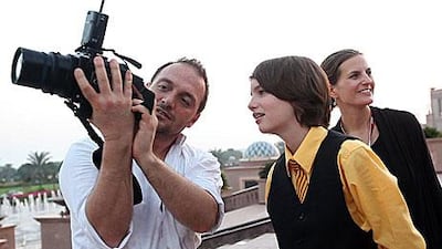 Fabrice Dall’Anese shows Kodi Smit-McPhee, an Australian actor, a photo during the Abu Dhabi Film Festival.