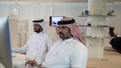 Employees at the offices at the Centre of Digital Innovation, a government initiative within the Telecommunications Regulatory Authority that tests apps for security and functionality before their use in the UAE. Razan Alzayani for The National
