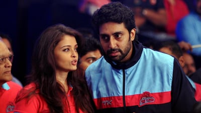 Indian Bollywood actors Aishwarya Rai Bachchan (L) and Abhishek Bachchan talk during a professional kabaddi league match in Mumbai on late July 26, 2014. Photo / AFP