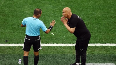Egypt coach Hossam Hassan talks to reserve referee Michael Orue during his team's match against New Zealand in the World Cup. Reuters