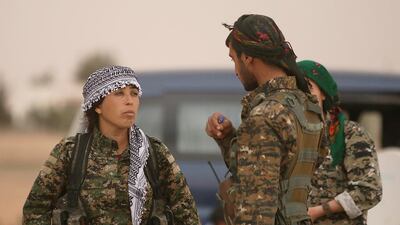 Rojda Felat, commander of a US-backed operation by Kurdish and Arab fighters to capture the Syrian city of Raqqa from ISIL, stands with fellow fighters near the Tabqa Dam, west of Raqqa, on March 30, 2017. Rodi Said / Reuters