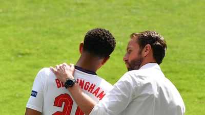 England's manager Gareth Southgate, right, talks with Jude Bellingham. AP