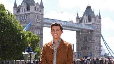 Tom Holland, in a striped shirt and tan suede jacket, attends a 'Spider-Man: Far From Home' photo call in London on June 17, 2019. Getty Images