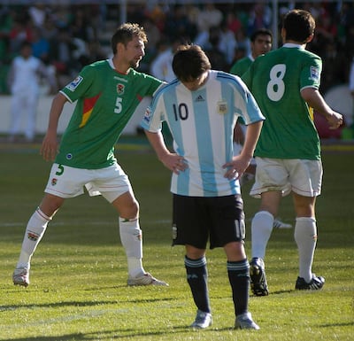 Lionel Messi reacts as Bolivia's Ronald Rivero (left) and Ronald Garcia (right) celebrate a goal during their 2010 World Cup qualifying match in La Paz on April 1, 2009. Reuters