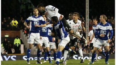 Clint Dempsey, No 23, jumps over Barry Ferguson, the Birmingham City midfielder, to score Fulham’s equaliser at Craven Cottage yesterday as the sides shared the spoils.