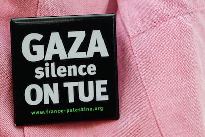 A demonstrator wears a badge reading 'Gaza, silence, we are killing' during a solidarity rally for Gaza and Palestine in Paris, France, on August 9. EPA