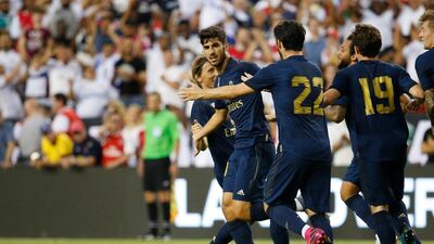 Real Madrid midfielder Marco Asensio celebrates with teammates after scoring. Reuters