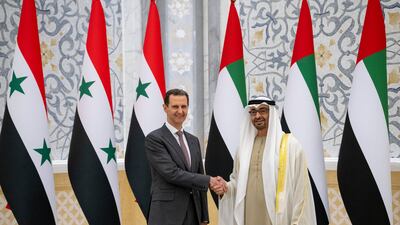 Sheikh Mohamed shakes hands with Mr Al Assad. Presidential Court