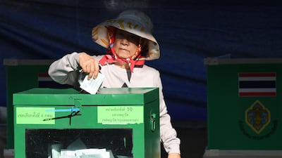 A woman casts her ballot at a polling station in Bangkok. AFP