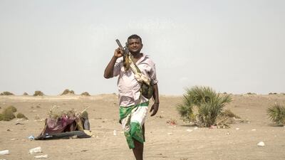 A member of the Tihama Resistence brigades walks at the coastal front line, May16, 2018. Asmaa Waguih for The National