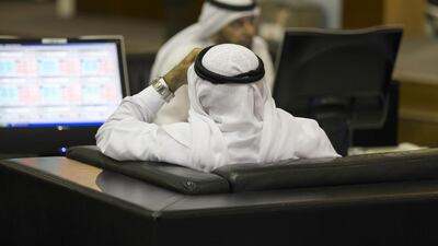 Traders in Dubai Financial Market at Dubai World Trade Centre. The DFM suffered its biggest fall since 2008 on Thursday. Reem Mohammed / The National