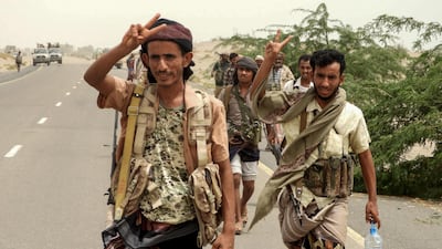 Yemeni pro-government forces flash the victory gesture as they arrive in Al Durayhimi district, about nine kilometres south of Hodeidah international airport on June 13, 2018.