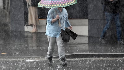 Pedestrians hold umbrellas as they walk in heavy rain in Sydney's central business district, New South Wales, Australia. EPA