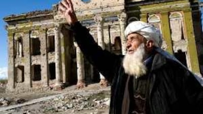 An elderly Afghan in a ravaged area of Kabul gestures as he speaks of God.