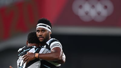 Fiji's Napolioni Bolaca (L) hugs Vilimoni Botitu after the match.