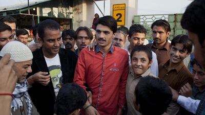 Pakistani tea vendor Arshad Khan, 18, center, surrounded by shopkeepers and colleagues at a market where he sells tea in Islamabad, Pakistan, on Friday, Oct. 21, 2016. B.K.Bangash AP Photo