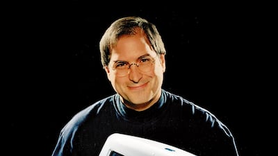 FILE - This 1998 file photo provided by Apple shows Apple CEO Steve Jobs holding an iMac computer. Jobs came back to Apple Inc. in (AP Photo/Moshe Brakha)