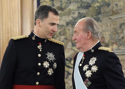 Spain's King Felipe (left) and his father, Juan Carlos in 2014. AFP