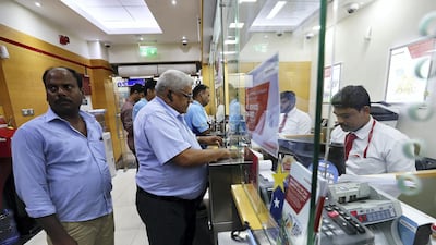 Customers at a UAE Exchange outlet in Dubai before it was placed under supervision by the UAE Central Bank in March last year. The consortium, which is in the process of buying parent group Finablr, is already planning bolt-on acquisitions. Pawan Singh / The National
