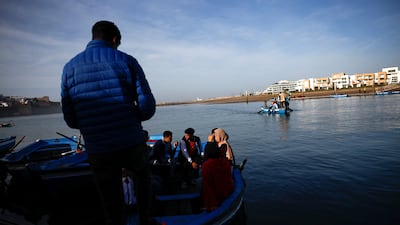People wait on board a wooden boat to cross Bou Regreg river in Rabat, Morocco, December 19, 2022. REUTERS / Juan Medina