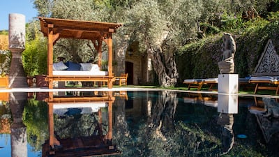 Day beds, sun loungers and age-old trees surround the swimming pool
