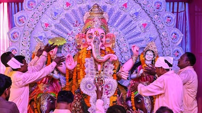 Devotees worship an idol of the elephant-headed Hindu deity Ganesha at a festival in Amritsar, India. AFP
