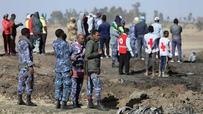 Ethiopian police standing near wreckage from Ethiopian Airlines Flight ET302, which crashed south-east of Addis Ababa. Reuters
