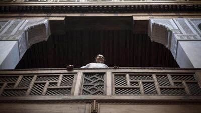 A woman stands in the balcony of a traditional building in the 9th century walled medina in the ancient Moroccan city of Fez on April 11, 2019. AFP