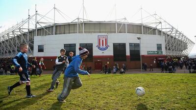 Children play football outside the Brittania Stadium prior to the match between Stoke City and Arsenal on Saturday March 1, 2014. Laurence Griffiths / Getty Images