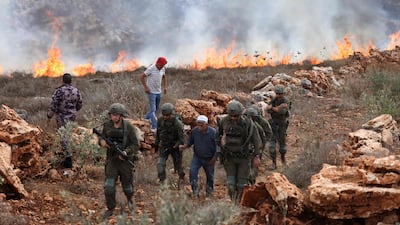 Fires burn after Israeli soldiers fired tear gas at Palestinians as they harvested their olives, south of the Israeli-occupied city of Nablus. AFP