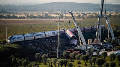 Cranes lift derailed carriages at the crash scene as rescue crews search for survivors. Reuters