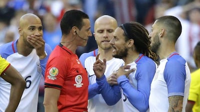 United States midfielder Jermaine Jones, second from right, protests to referee Wilmar Roldan, second from left, after Roldan gave Jones a red card in the second half of a Copa America Centenario soccer match against Ecuador, Thursday, June 16, 2016 at CenturyLink Field in Seattle. The United States beat Ecuador 2-1. (AP Photo/Ted S. Warren)