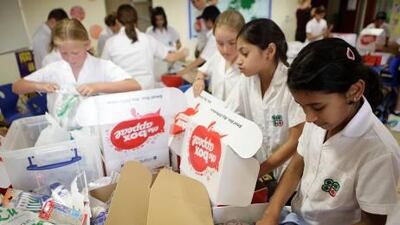 Students at the Raha International School in Abu Dhabi pack boxes full of grooming items to be given to labourers as part of the Box Appeal charity initiative.