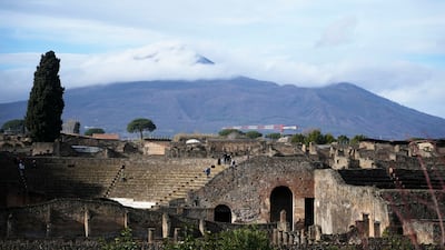 The Mt. Vesuvius volcano towers over the remains of the ancient town of Pompeii in southern Italy, Tuesday, Feb. 15, 2022. In a few horrible hours, Pompeii went from being a vibrant city to a dead one, smothered by a furious volcanic eruption in 79 AD. Then in this century, Pompeii appeared alarmingly on the precipice of a second death, assailed by decades of neglect, mismanagement and scanty systematic maintenance of heavily visited ruins. (AP Photo / Gregorio Borgia)