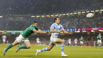 Argentina’s Juan Imhoff, right, races clear of Ireland’s Rob Kearney to touch the ball down for a try. Christophe Ena / AP Photo