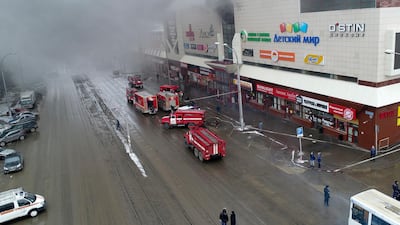 Smoke rises above a multi-story shopping centre in the Siberian city of Kemerovo. Russian Ministry for Emergency Situations photo via AP