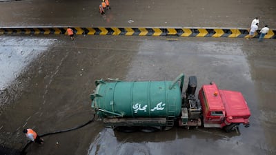 Municipal workers clear the roads after heavy rain in Kuwait City. EPA