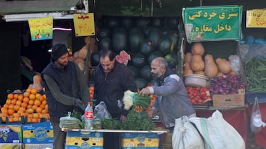 Iranians go shopping in a market in Tehran, though some bazaars have closed while traders hold protests over rising inflation. EPA