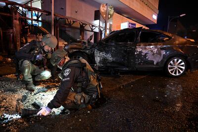 Israeli police inspect the scene of a rocket strike in the border town of Kiryat Shmona. Reuters