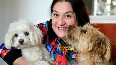 Varga poses with her dogs at her workshop in Budapest. AFP
