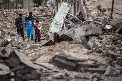 Civilians walking to a food distribution point during the battle for Mosul in 2017. Getty Images