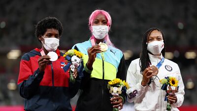 Gold medalist Shaunae Miller-Uibo, centre, of the Bahamas, silver medalist Marileidy Paulino, left, of the Dominican Republic and bronze medalist Allyson Felix of the USA pose on the podium during the medal ceremony for the women's 400m.