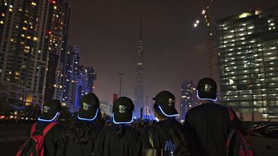 Onlookers watch the Burj Khalifa going dark during Earth Hour. Jeff Topping for The National