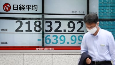 A man walks past a stock market indicator board in Tokyo, Japan. Experts say entire stock markets can be swayed by emotional extremes. EPA