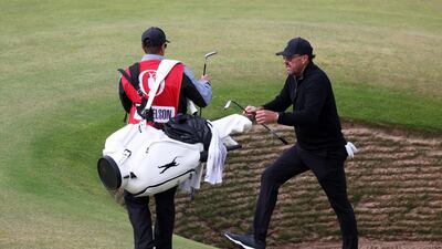 Phil Mickelson of the US climbs out of a bunker on the 17th hole. Getty